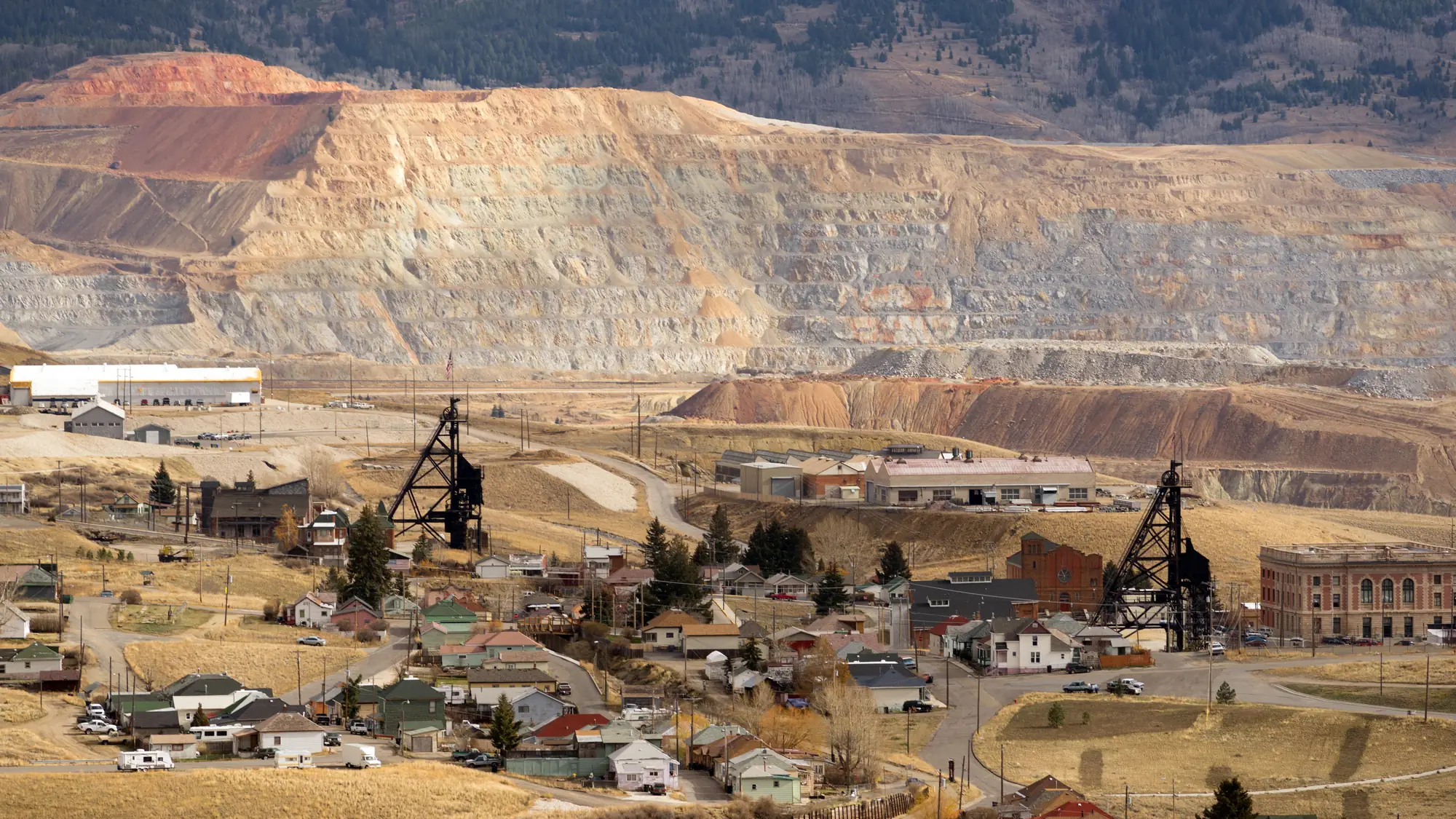 Butte, Montana: steel headframes standing over the town with the terraced Berkeley Pit behind