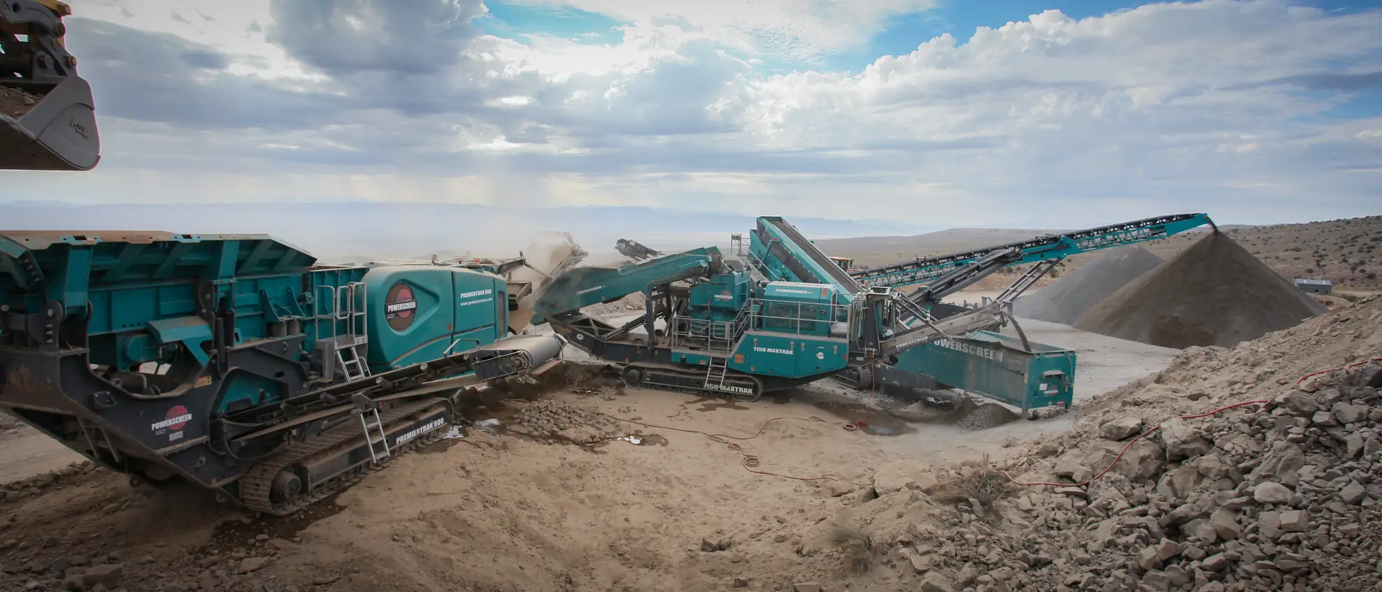 A primary crusher and conveyor gallery at an American mine site, ore stockpiled below